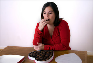 istock_000005188435xsmall-depressed-woman-eating-chocolate-from-heart.jpg